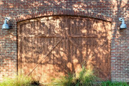 pair of barn doors on a brick barn farm buildingの写真素材