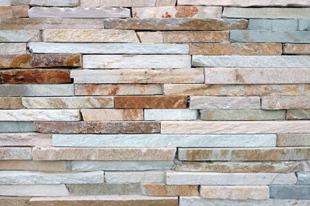 detailed white tan brown rust slim cut slate rock wall close-up