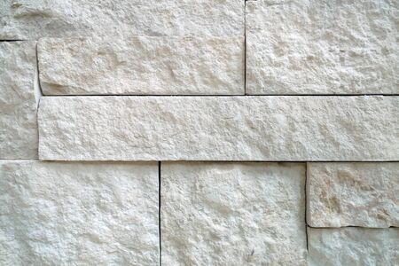 a white block detailed slate rock wall close-up shadowingの写真素材