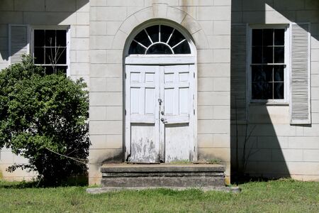 a pair of vintage southern stone abandoned church doorsの写真素材