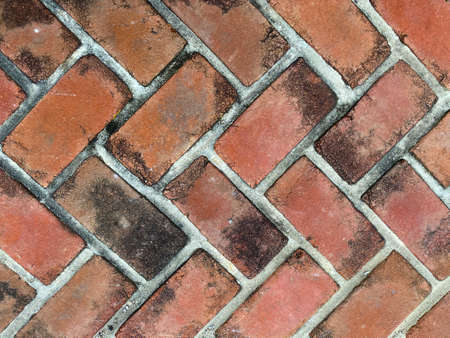 red old faded dirty close-up cobblestone pattern brick pave, rich colors and shadows suitable for...