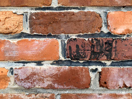 vintage close-up view old textured red black brick wall, rich colors and shadows suitable for...