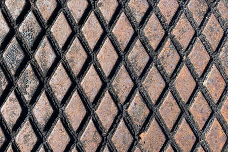 rusty retro close-up view diamond plate storm drain cover suitable for website marketing background...