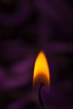closeup of orange flame with soothing purple backgroundの写真素材