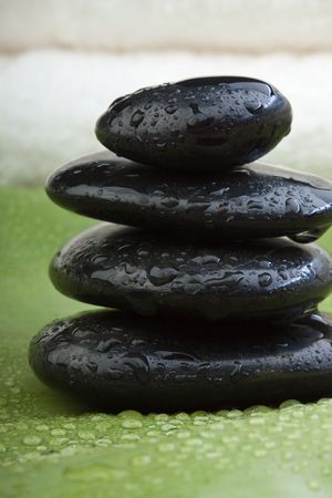 wet hotstones on banana leaf with white towel in backgroundの写真素材