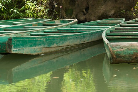 Green wooden boats anchored on river (2)の写真素材