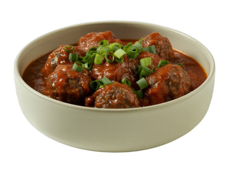 Close-up overhead shot of delicious meatballs in a rich tomato sauce, garnished with fresh spring onions and herbs. This appetizing image is perfect for food blogs, restaurant menus, cookbooks, and websites. The high-quality, transparent PNG file is ideal for various design projects thanks to its clean white background.の写真素材