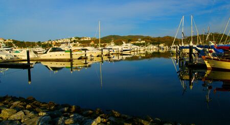 Quiet boats at yacht club in the sunrise with blue skyの写真素材
