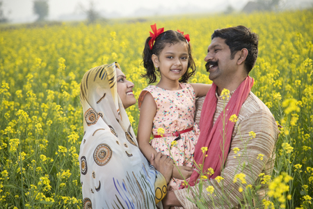 Rural happy Indian family in agricultural fieldの写真素材