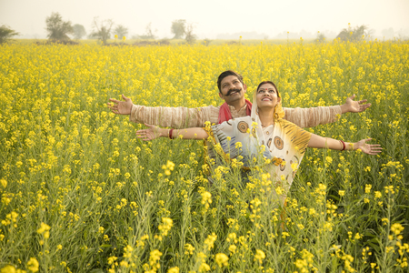 Rural Indian couple in agricultural fieldの写真素材