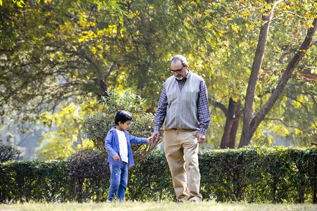 Grandfather playing with grandson at park