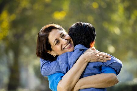 Woman embracing grandson at parkの写真素材