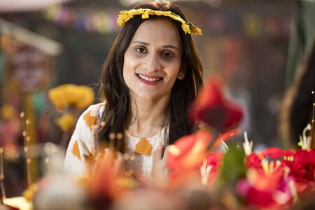Women trying on floral tiara at street marketの写真素材