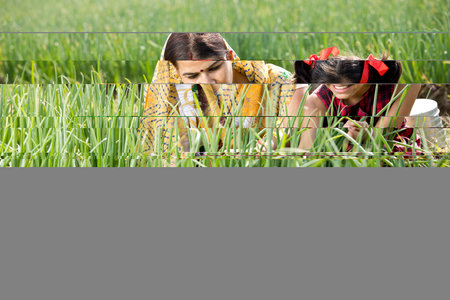 Rural mother with daughter in agricultural fieldの写真素材