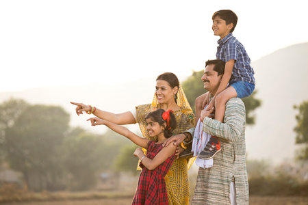 Happy rural Indian family on agricultural fieldの写真素材