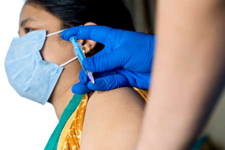 Doctor injecting vaccine into arm of patient