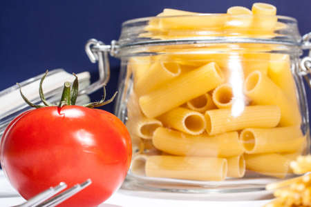 Raw italian food: pasta and tomatoの写真素材