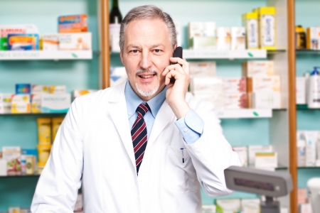 Smiling pharmacist talking on the phoneの写真素材