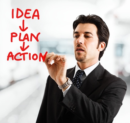 Portrait of a businessman writing an acrion plan on the screenの写真素材