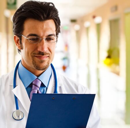 Portrait of a smiling handsome doctorの写真素材