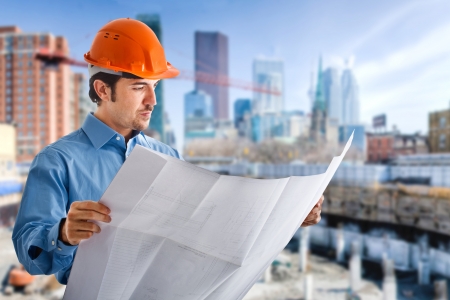 Portrait of a site manager reading a blueprintの写真素材
