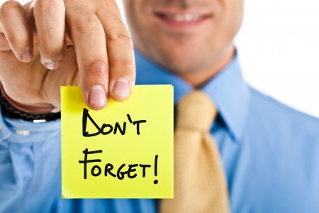 Businessman reminding something using a post-itの写真素材