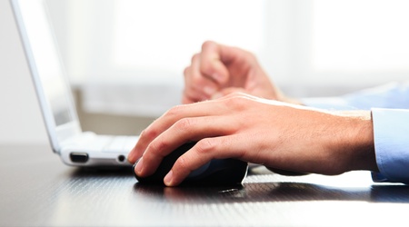 Close-up of a worker using a laptop computerの写真素材