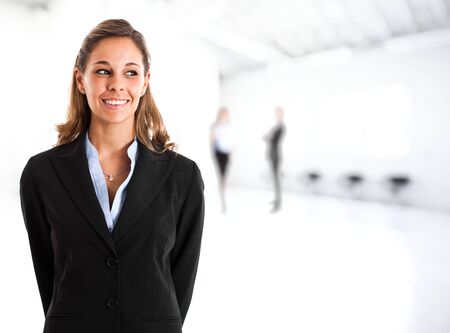 Portrait of a smiling businesswoman  Bright blurred backgroundの写真素材