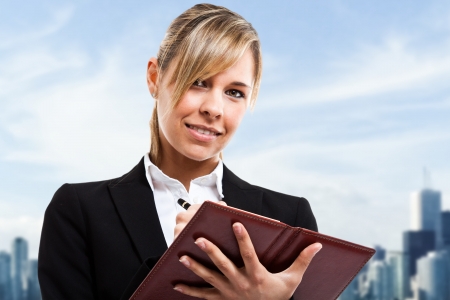 Business woman writing on her notebookの写真素材