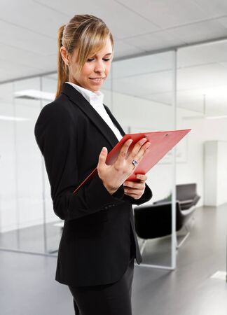 Portrait of a beautiful woman reading a documentの写真素材