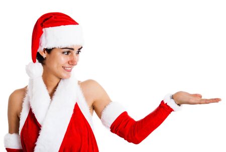 Beautiful girl wearing a Santa Claus dress looking at her empty handの写真素材