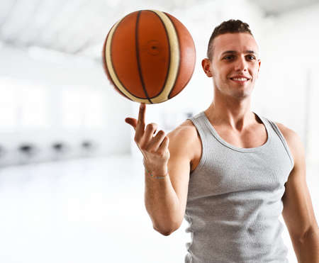 Young athlete holding a basketballの写真素材