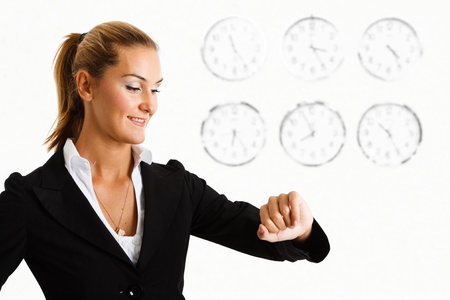 Portrait of a smiling businesswoman looking at her watchの写真素材