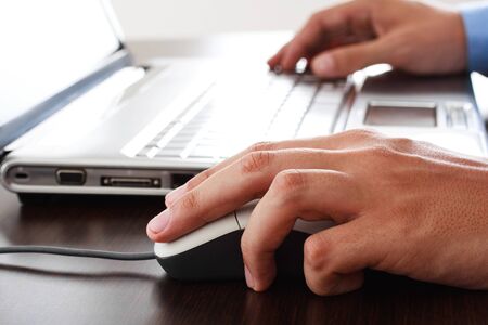 Close-up of a worker using a laptop computerの写真素材
