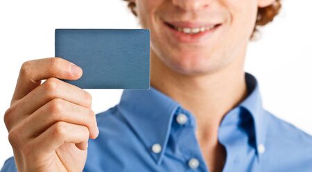 Handsome businessman showing a blank cardの写真素材