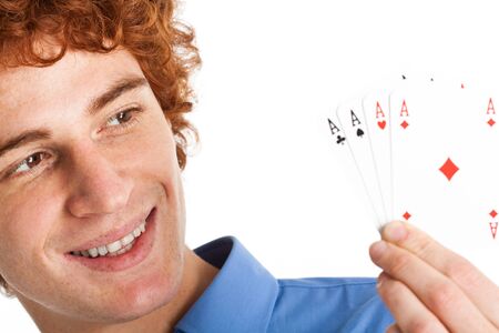 Young happy man showing four acesの写真素材