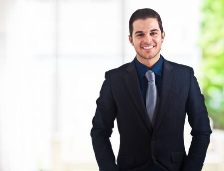 Portrait of an handsome smiling businessmanの写真素材