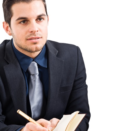 Business man writing on a notebookの写真素材