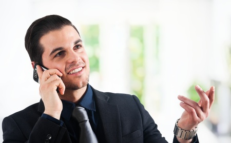 Portrait of a young businessman using a smartphoneの写真素材