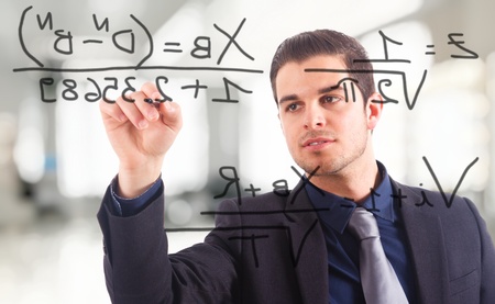 Young businessman writing math formulas on the screen.