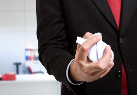 Businessman crumpling a document in his officeの写真素材