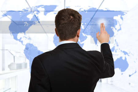 Businessman touching a digital world map