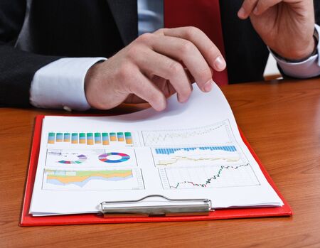 Businessman examining a financial documentの写真素材