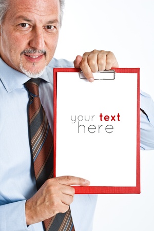 Mature businessman holding an empty sheet of paperの写真素材