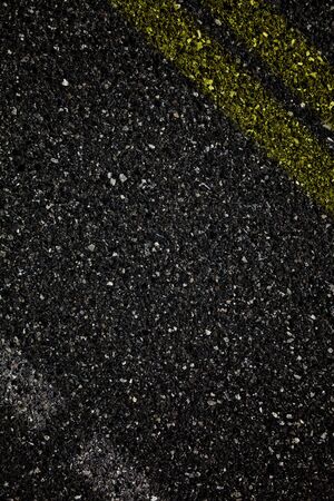 Asphalt background with yellow stripes