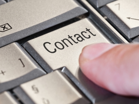 Close-up of a finger pressing the  contact  key