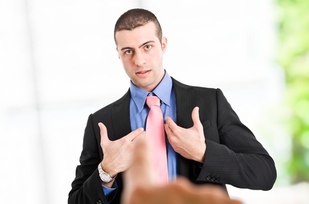 Boss pointing the finger to an employeeの写真素材