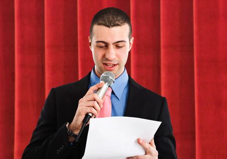 Portrait of a man speaking in a microphoneの写真素材