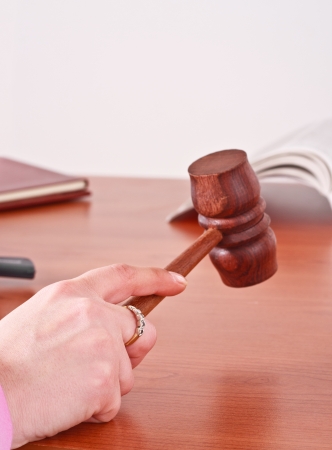 Judge handling a gavel in a courtroomの写真素材
