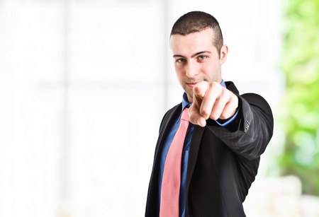 Handsome man pointing his finger to you. Isolated on whiteの写真素材